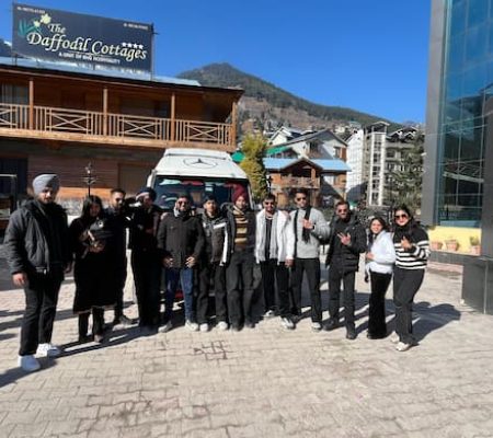 Group of happy travelers in front of a spacious Tempo Traveller – Book with Bawa Taxi Services, the best taxi service in Chandigarh.